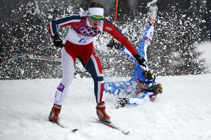 Italy’s Greta Laurent falls as Norway’s Ingvild Flugstad Oestberg skis past as they compete in the Women’s Cross-Country Skiing Individual Sprint Free Quarterfinals at the Laura Cross-Country Ski and Biathlon Center during the Sochi Winter Olympics on February 11, 2014 in Rosa Khutor near Sochi. (Pierre-Philippe Marcou/AFP/Getty Images)