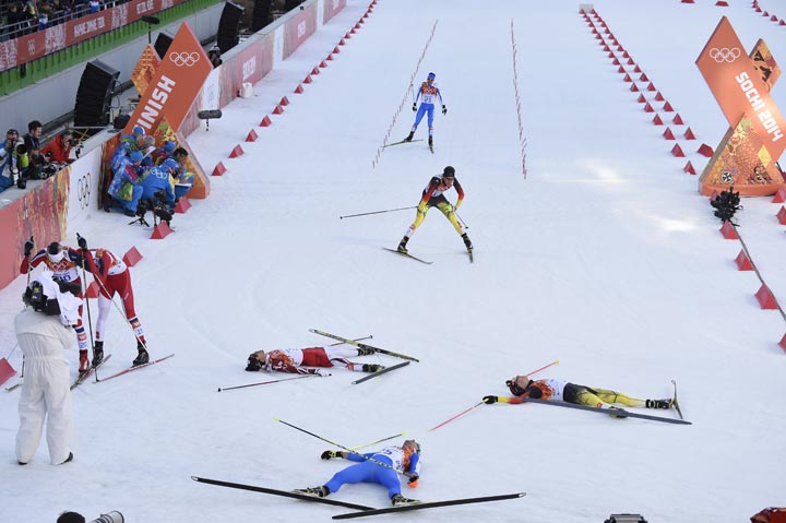 Gold medalist Germany’s Eric Frenzel (R), silver medalist Japan’s Akito Watabe (L) and fourth place Italy’s Alessandro Pittin (15-front) lie on the snow at the finish line of the Nordic Combined Individual 10 km Cross-Country at the Russki Gorki Jumping Center during the Sochi Winter Olympics on February 12, 2014 in Rosa Khutor near Sochi. (Odd Andersen/AFP/Getty Images)