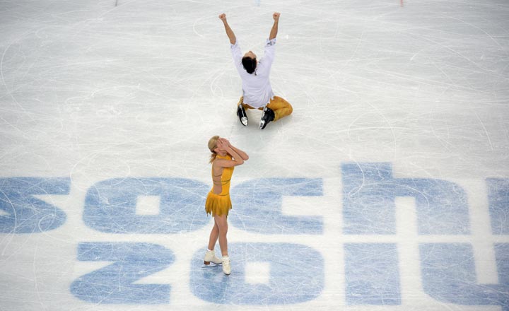 Russia’s Tatiana Volosozhar and Russia’s Maxim Trankov reacts after performing their Figure Skating Pairs Free Program at the Iceberg Skating Palace during the Sochi Winter Olympics on February 12, 2014. (Yuri Kadobnov/AFP/Getty Images)
