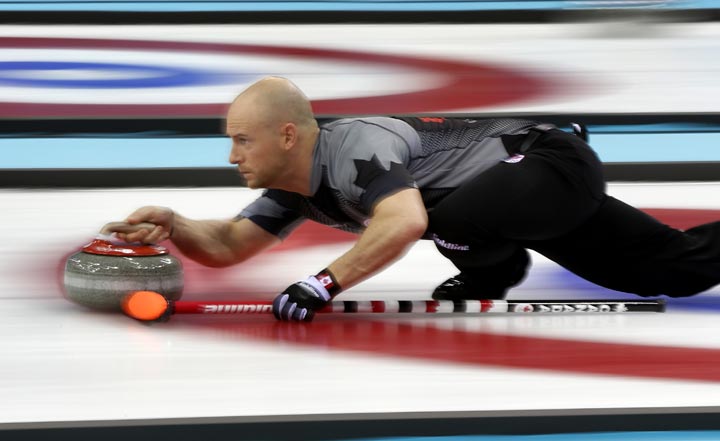 Canada’s vice-skip Ryan Fry delivers the rock during the men’s curling competition against Denmark at the 2014 Winter Olympics, Thursday, Feb. 13, 2014, in Sochi, Russia. (AP Photo/Robert F. Bukaty)