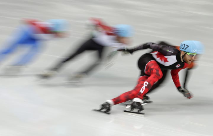 Olivier Jean of Canada competes in a men’s 1000m short track speedskating heat at the Iceberg Skating Palace during the 2014 Winter Olympics, Thursday, Feb. 13, 2014, in Sochi, Russia. (AP Photo/Bernat Armangue)