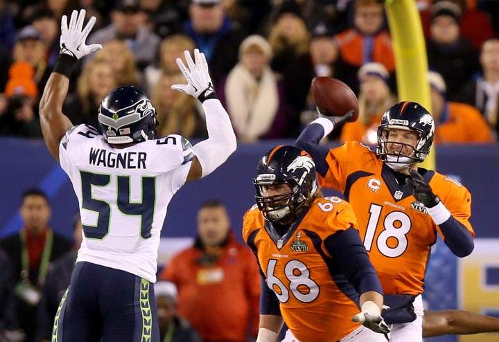 Quarterback Peyton Manning of the Denver Broncos throws an interception caught by strong safety Kam Chancellor and intended for tight end Julius Thomas of the Denver Broncos in the first quarter during Super Bowl XLVIII at MetLife Stadium on February 2, 2014 in East Rutherford, New Jersey. (Jeff Gross/Getty Images)