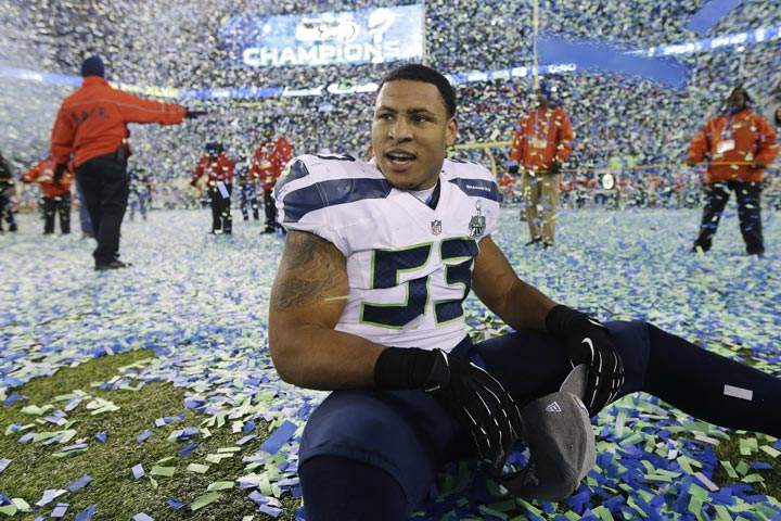 Seattle Seahawks’ Malcolm Smith sits on the field after the NFL Super Bowl XLVIII football game against the Denver Broncos Sunday, Feb. 2, 2014, in East Rutherford, N.J. The Seahawks won 43-8. (AP Photo/Ben Margot)