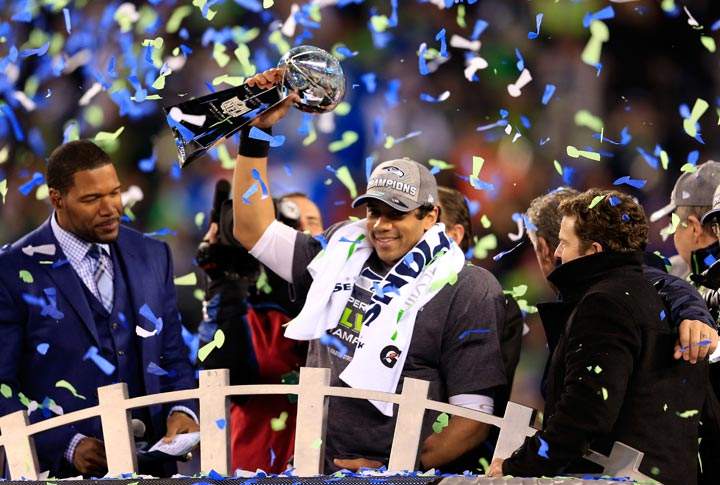 Russell Wilson of the Seattle Seahawks celebrates with the Vince Lombardi trophy after defeating the Denver Broncos 43-8 in Super Bowl XLVIII at MetLife Stadium on February 2, 2014 in East Rutherford, New Jersey. (Rob Carr/Getty Images)