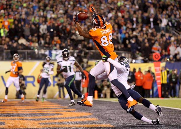Wide receiver Demaryius Thomas of the Denver Broncos ran 14 yards to score a touchdown in the third quarter against cornerback Byron Maxwell of the Seattle Seahawks during Super Bowl XLVIII at MetLife Stadium on February 2, 2014 in East Rutherford, New Jersey. (Jeff Gross/Getty Images)