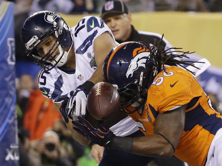 Denver Broncos' Nate Irving, right, breaks up a pass intended for Seattle Seahawks' Jermaine Kearse during the first half of the NFL Super Bowl XLVIII football game Sunday, Feb. 2, 2014, in East Rutherford, N.J. (AP Photo/Matt Slocum) 
.