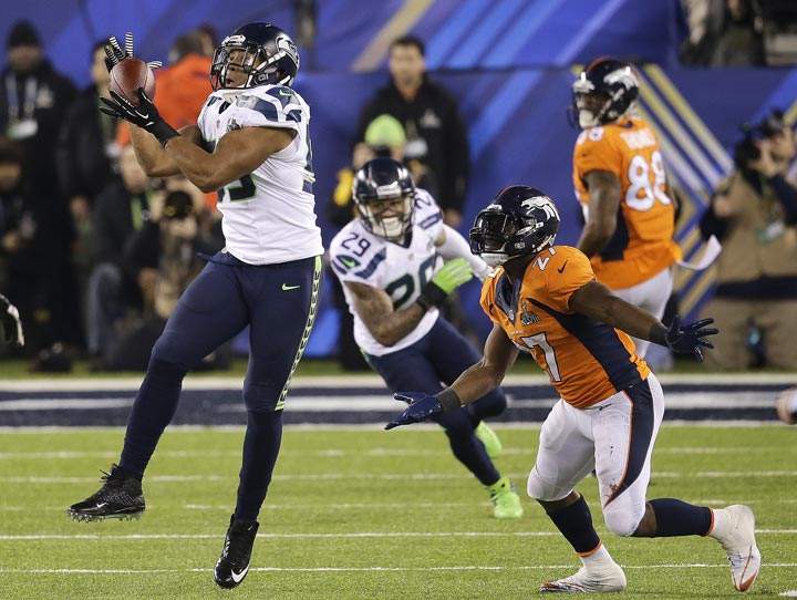 Seattle Seahawks outside linebacker Malcolm Smith intercepts a pass intended for Denver Broncos running back Knowshon Moreno during the first half of the NFL Super Bowl XLVIII football game Sunday, Feb. 2, 2014, in East Rutherford, N.J. Smith ran the interception back for a touchdown. (AP Photo/Chris O’Meara)