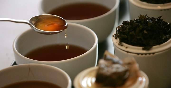 A tea broker prepares to tastes a cup of pure English tea.