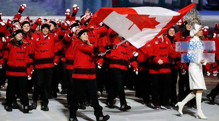 Hayley Wickenheiser of Canada carries the national flag as she leads the team during the opening ceremony of the 2014 Winter Olympics in Sochi, Russia, Friday, Feb. 7, 2014. 