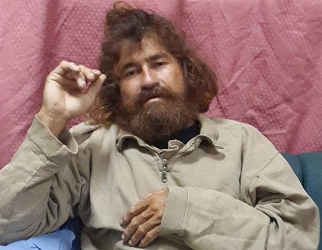 In this Feb. 3, 2014 file photo provided by the Marshall Islands Foreign Affairs Department, a man identifying himself as Jose Salvador Alvarenga sits on a couch in Majuro in the Marshall Islands, after he was rescued from being washed ashore on the tiny atoll of Ebon in the Pacific Ocean. 