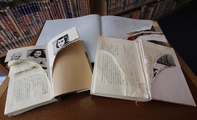 Ripped copies of Anne Frank's "Diary of a Young Girl" and related books are shown at Shinjuku City Library in Tokyo Friday, Feb. 21, 2014.
