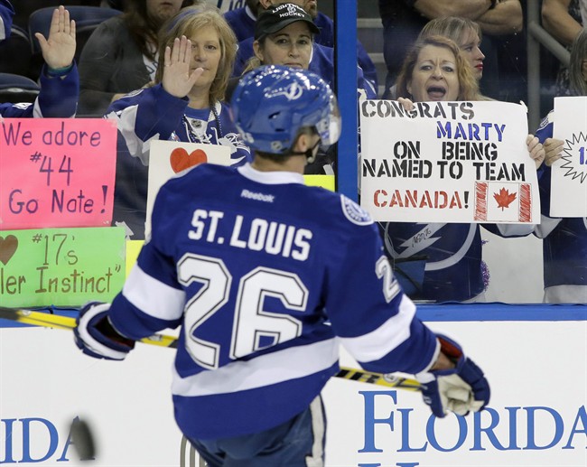 A fan holds up a sign congratulatingTampa Bay Lightning right winger Martin St. Louis (26) for being selected to the Canadian Olympic hockey team before an NHL hockey game against the Toronto Maple Leafs Thursday, Feb. 6, 2014, in Tampa, Fla. St. Louis replaces teammate Steven Stamkos, who is still recovering from a broken leg.