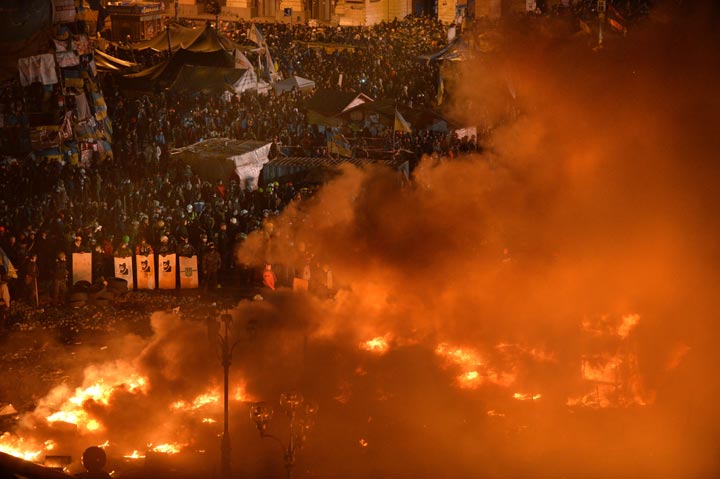 Anti-government protesters clash with the police during their storming of Independence Square in Kyiv on February 18, 2014. 