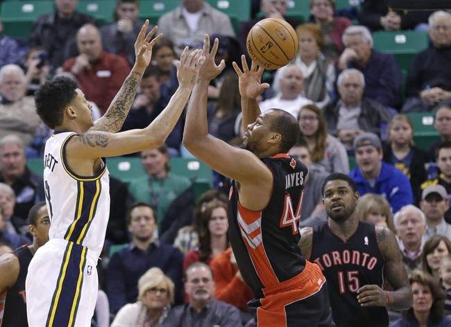Utah Jazz's Diante Garrett, left, and Toronto Raptors' Chuck Hayes (44) reach for the ball as Toronto Raptors' Amir Johnson (15) looks on in the second quarter of an NBA basketball game, Monday, Feb. 3, 2014, in Salt Lake City.