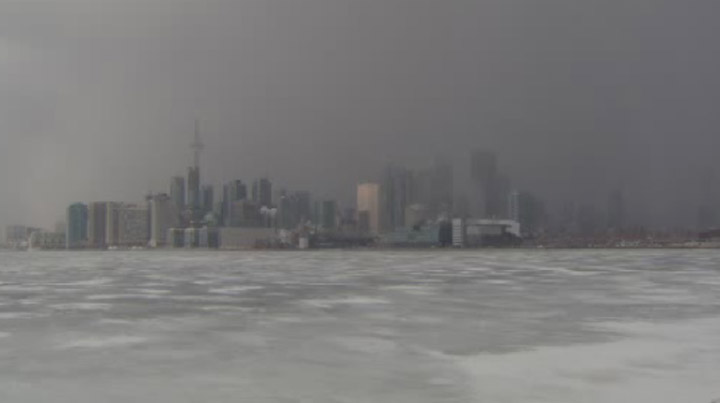 A wall of snow moves through downtown Toronto on Feb. 27, 2014.