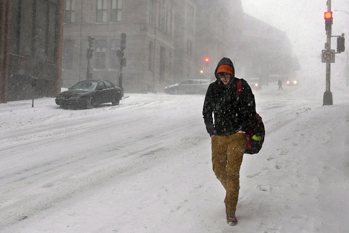 A man walks through the snow on a downtown street in Halifax on Jan. 22, 2014.