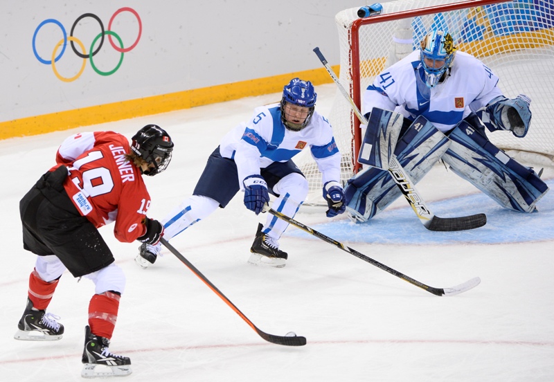 Canada's Brianne Jenner (L) attempts to score against Finland's goalkeeper Noora Raty during the Women's Ice Hockey Group A match Finland vs Canada at the Shayba Arena during the Sochi Winter Olympics on February 10, 2014. AFP PHOTO / JONATHAN NACKSTRAND.