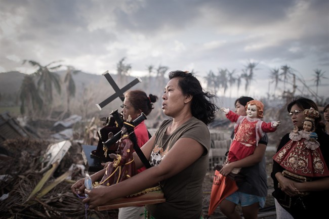 In this photo provided on Friday Feb. 14, 2014 by World Press Photo, the 1st prize in the Spot News Single category of the 2014 World Press Photo Contest by Phillipe Lopez, France, Agence France-Presse, shows survivors of typhoon Haiyan march during a religious procession in Tolosa, on the eastern island of Leyte, Philippines, Nov. 18, 2013.