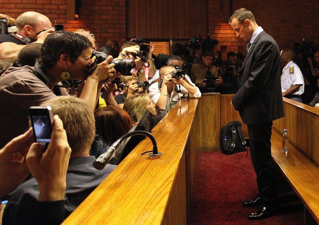  In this Wednesday, Feb. 20, 2013 file photo Olympic athlete Oscar Pistorius stands inside a court during his bail hearing at the magistrate court in Pretoria, South Africa. Pistorius will defend himself March 3, 2014 against a charge of premeditated murder in the slaying of his girlfriend Reeva Steenkamp. A South Africa judge has ruled that television stations can broadcast parts of the trial live, but with restrictions on witness testimonies. (AP Photo/Themba Hadebe, File).