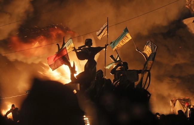 Monuments to Kiev's founders burn as anti-government protesters clash with riot police in Kyiv, Ukraine onTuesday, Feb. 18, 2014. 
