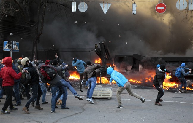 Anti-government protesters clash with riot police outside Ukraine’s parliament in Kyiv, Ukraine, Tuesday, Feb. 18, 2014. Ukraine’s festering political crisis took a deadly turn Tuesday, as thousands of anti-government protesters clashed with police outside Ukraine’s parliament.