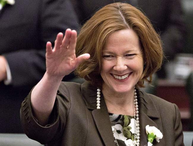 Alberta Premier Alison Redford waves to members of the legislative assembly before the throne speech at the Alberta Legislature in Edmonton, Alberta on Monday March 3, 2014. Redford says she will pay back the $45,000 it cost for her and an assistant to fly to South Africa for Nelson Mandela's funeral. THE CANADIAN PRESS/Jason Franson.