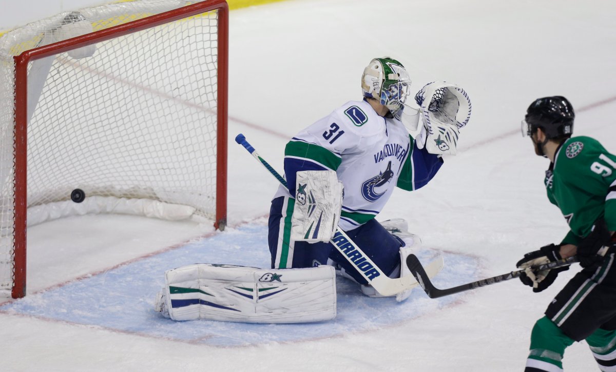 Dallas Stars center Tyler Seguin (91) scores a goal against Vancouver Canucks goalie Eddie Lack (31) during the first period of an NHL hockey game Thursday, March 6, 2014, in Dallas. (AP Photo/LM Otero).