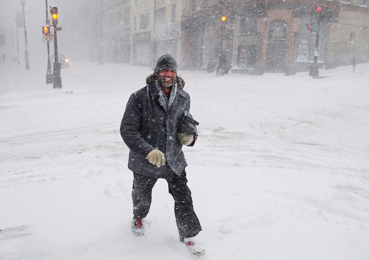 A pedestrian battles the high winds and blowing snow as he walks in downtown Halifax on Wednesday, March 26, 2014.