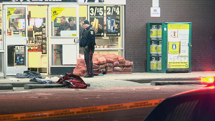 Police investigate outside a Main Street 7-Eleven following a triple stabbing on Wednesday morning.