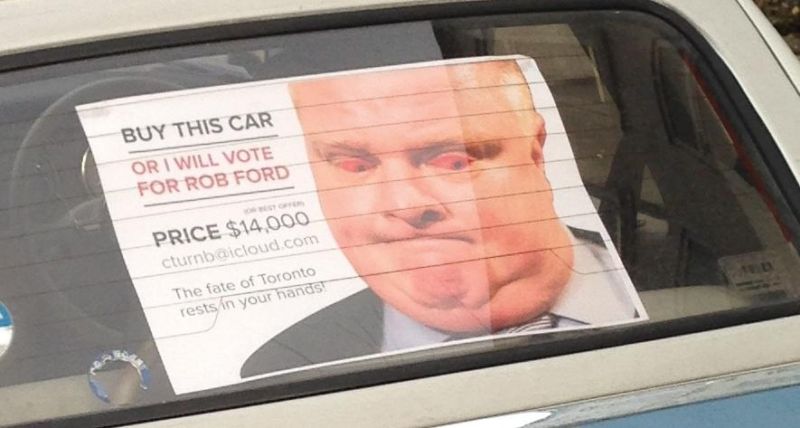 Toronto car owner Colin Turnbull places a poster of Rob Ford in a vehicle for sale.