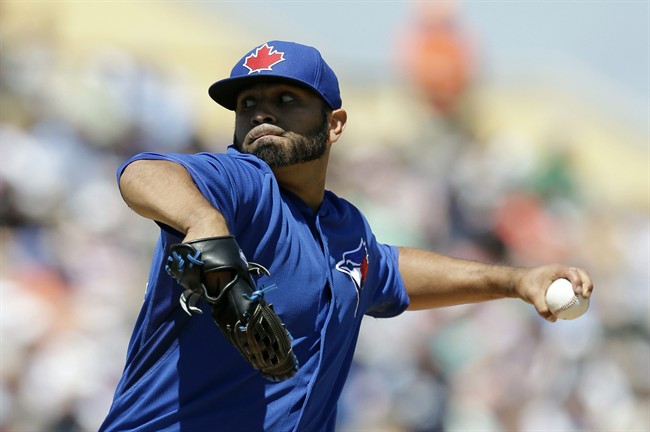 Toronto Blue Jays starting pitcher Ricky Romero throws during the first inning of a spring exhibition baseball game against the Detroit Tigers in Lakeland, Fla., Tuesday, March 18, 2014.