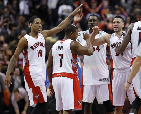 Raptors celebrate their win.  Toronto Raptors vs Golden State Warriors during 2nd half action of NBA play on March 2, 2014 at the Air Canada Centre. Raptors won 104-98. 