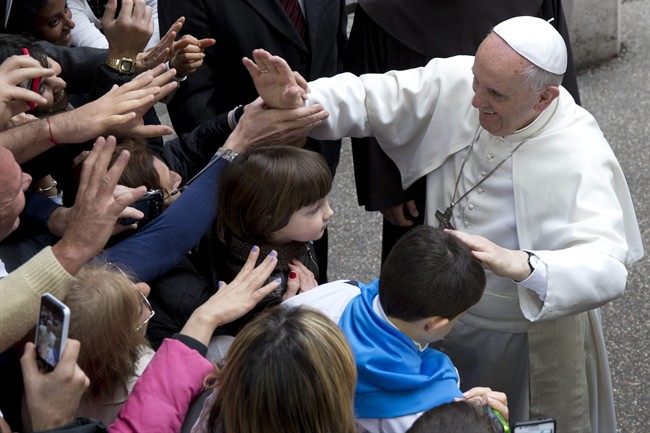 Pope Francis greets faithful as he arrives for a meeting with relatives of innocent mafia victims, in Rome's St. Gregorio VII church, just outside the Vatican, Friday, March 21, 2014. (AP Photo/Andrew Medichini).