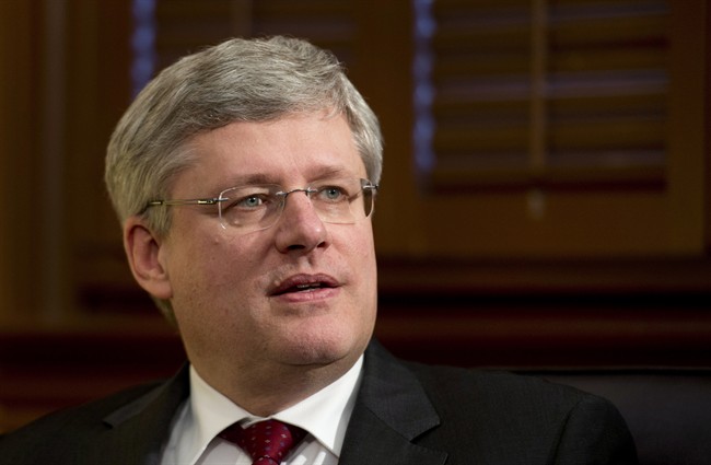Canadian Prime Minister Stephen Harper waits for a meeting to begin in Ottawa, Monday March 17, 2014. 