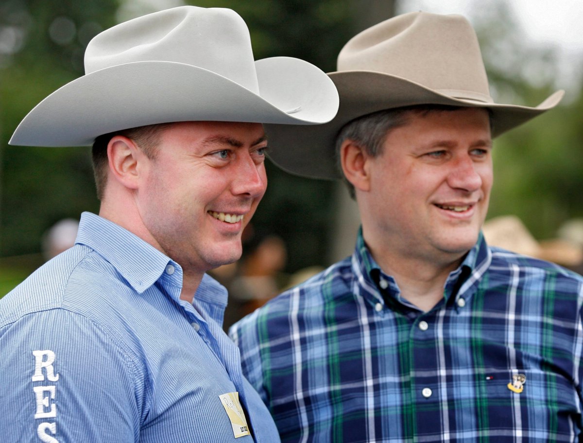 Prime Minister Stephen Harper, right, and MP Rob Anders pose for a picture as they attend a Stampede breakfast at Heritage Park in Calgary, Sunday, July 8, 2007.