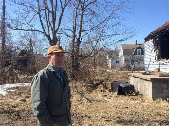 Score beside a burned and abandoned house and a garage behind him that was just discovered last week while clearing out wild brush.
