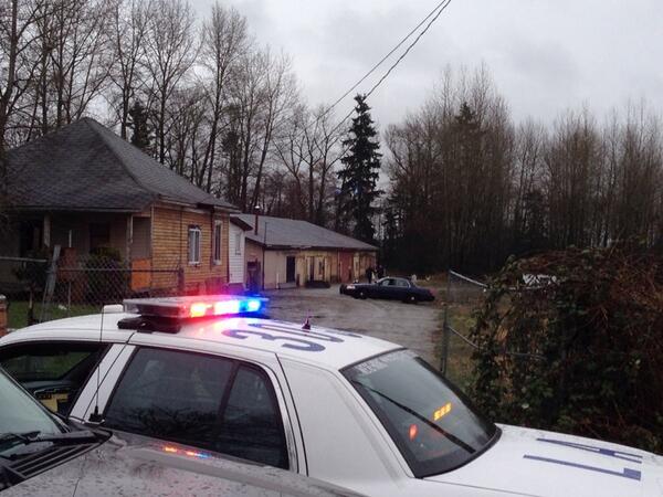 Police investigate after a shooting at a Langley home on March 16, 2014.