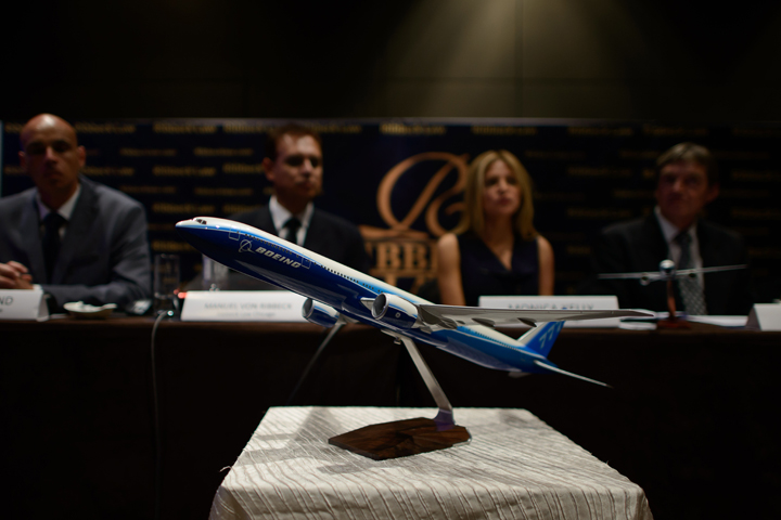 A model of a Boeing 777 aircraft is displayed as representatives of US law firm Ribbeck Law Chartered International hold a media briefing at a hotel in Kuala Lumpur on March 26, 2014.