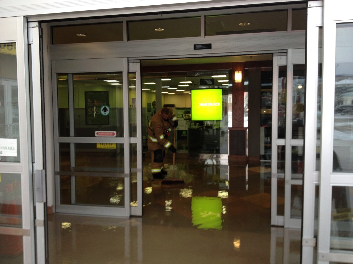 Shop tenants cleanup after major flood at NW Calgary mall - image