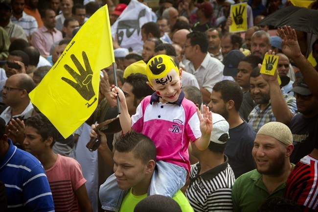 FILE - In this Friday, Sept. 27, 2013 file photo, A young Egyptian boy participates in a demonstration by supporters of ousted President Mohammed Morsi in the Maadi district of Cairo, Egypt. A court in southern Egyptian has convicted 529 supporters of ousted Islamist President Mohammed Morsi, sentencing them to death on charges of murdering a policeman and attacking police.