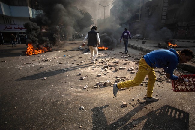 In this Saturday, Jan. 25, 2014 file photo, protesters clash with security forces in the Mohandiseen district of Cairo, Egypt. On Sunday, Feb. 2, 2014