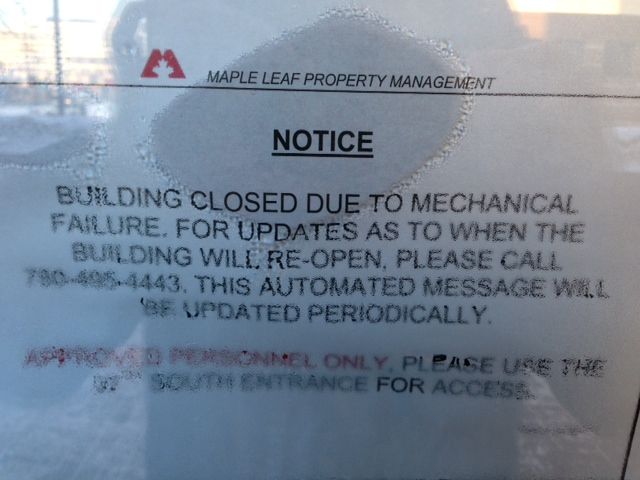 A note has been posted on one of the doors at Edmonton’s Canada Place building, informing people about the building’s closure.
