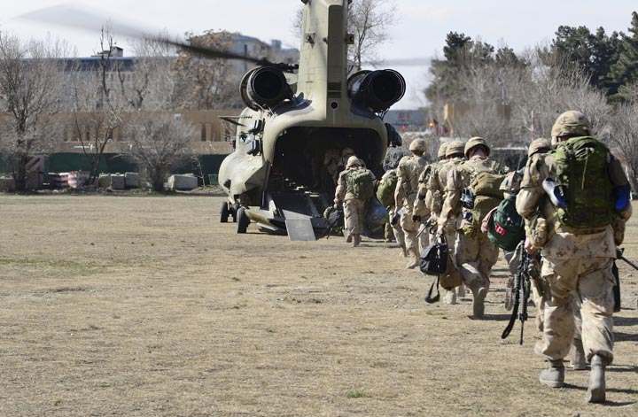The last Canadians involved in the NATO training mission in Afghanistan (CCTM-A) board an American Chinook helicopter, on March 12, 2014 as they leave the International Security Assistance Force (ISAF) headquarters in Kabul, Afghanistan.

