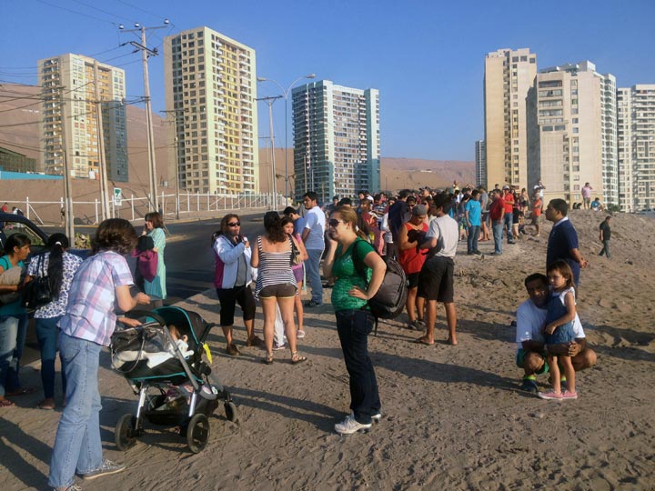 People wait in high areas after hearing a tsunami alert following a quake in Iquique, 1800 km north of Santiago, Chile, on March 16, 2014. 
