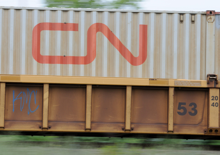 In this FILE photo, a CN Rail logo on container speeding along the mainline. The Canadian National Railway says it will phase out its own small fleet of 183 DOT-111 tank cars over the next four years as part of a plan to improve safety at the country's largest railway.