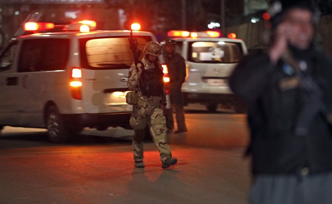 An Afghan policeman walks at the site of a gun battle in Serena Hotel in Kabul, Afghanistan, Thursday, March 20, 2014. 