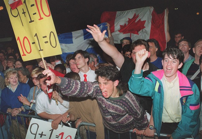 Demonstrators show their support for the Meech Lake Accord as the premiers leave the conference centre breaking off for the day at the constitutional talks in Ottawa in a June 6, 1990 file photo. 