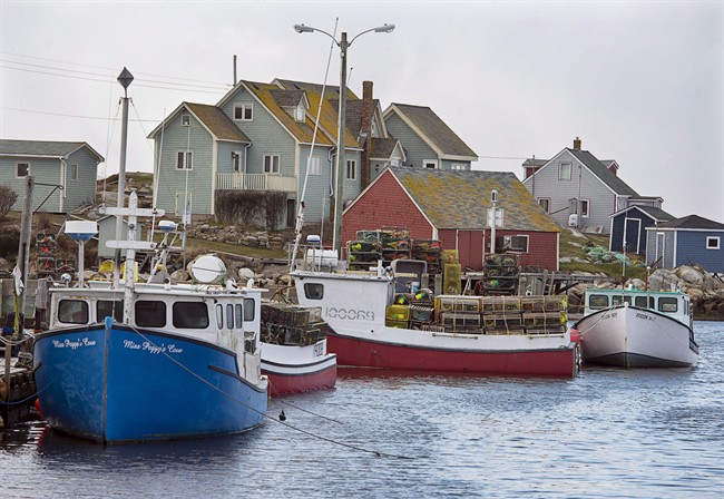 Fishing boats sit loaded with lobster traps in Peggys Cove, N.S. on Friday, Nov. 29, 2013. 