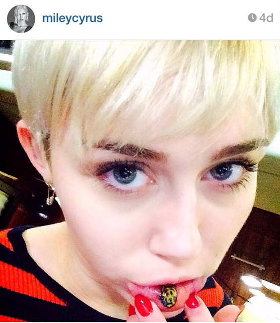 Singer Miley Cyrus shows off a lower lip tattoo in a photo posted on her Instagram account.