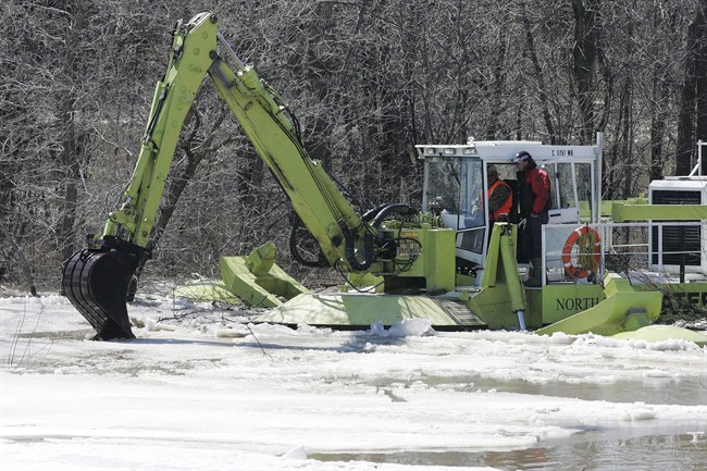 The machines ice-jam mitigation. The front pedestal of the 22-ton machines has been reinforced to support hydraulic boom arms, which pulls the Amphibex onto solid ice.